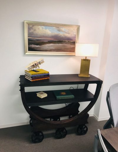 A table with books and a lamp on it