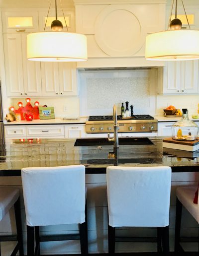 A kitchen with white cabinets and a large island.