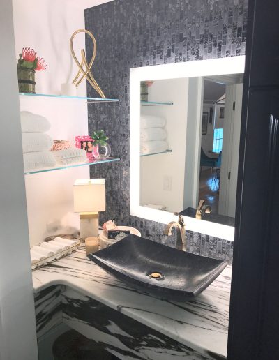 A bathroom with a sink and mirror in it